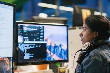 Engineer looking intently at the code on her computer screen