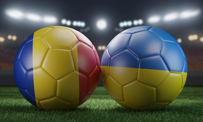 Two soccer balls in flags colors on a stadium blurred background. Group E. Romania and Ukraine. 3D image.