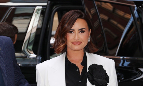 Demi Lovato stuns at Vogue dinner party with chic black and white outfit and Hello Kitty flower