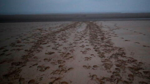 Footprints on a beach near Wimereux, northern France, on 24 November 2021. The area is a point of departure for migrants seeking to cross the English Channel by boat.