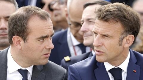 French President Emmanuel Macron, right, speaks with French Defense Minister Sebastien Lecornu during the International Paris Air Show at the Paris Le Bourget airport, north of Paris, Monday, June 19, 2023. (Ludovic Marin, Pool via AP)