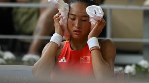 China's Zheng Qinwen tries to cool down during a break between her tennis match at the Roland-Garros Stadium in Paris on July 31, 2024.