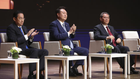 Japanese Prime Minister Fumio Kishida, from left, South Korean President Yoon Suk Yeol and Chinese Premier Li Qiang attend a business meeting at the Korea Chamber of Commerce and Industry in Seoul, So