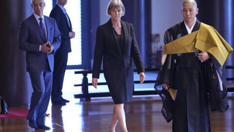 U.S. Ambassador to Japan Rahm Emanuel, left, and British Ambassador to Japan Julia Longbottom, center, are led for prayers by a Buddhist monk, during an annual ceremony at Zojoji temple to honor the N