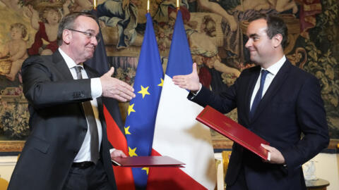 French Defense Minister Sebastien Lecornu , right, and his German counterpart Boris Pistorius shakes hands after signing an agreement in Paris Friday, April 26, 2024. The ministers ratified the divisi