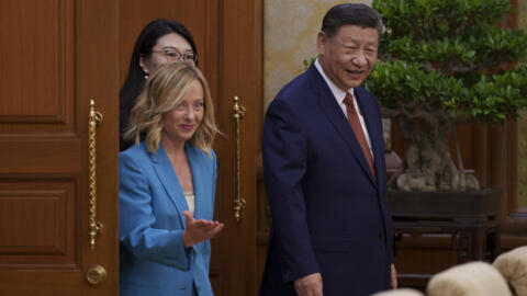 Chinese President Xi Jinping, right, walks with Italian Premier Giorgia Meloni, left, for a meeting at the Diaoyutai State Guesthouse in Beijing, China, Monday, July 29, 2024.