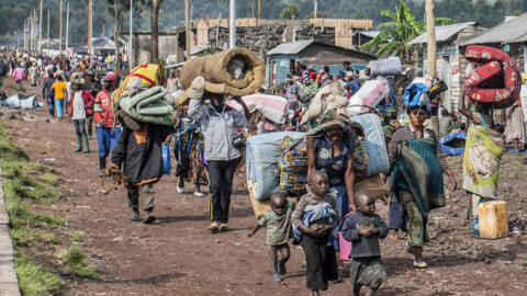 People fleeing the fighting between government forces and M-23 rebels make their way towards Goma, Democratic Republic of Congo in November 2022. 