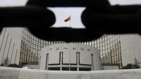 The headquarters of the People's Bank of China, the central bank, is pictured behind an iron chain in Beijing