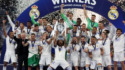 Real Madrid's Marcelo celebrates with the trophy and teammates after winning the Champions League.