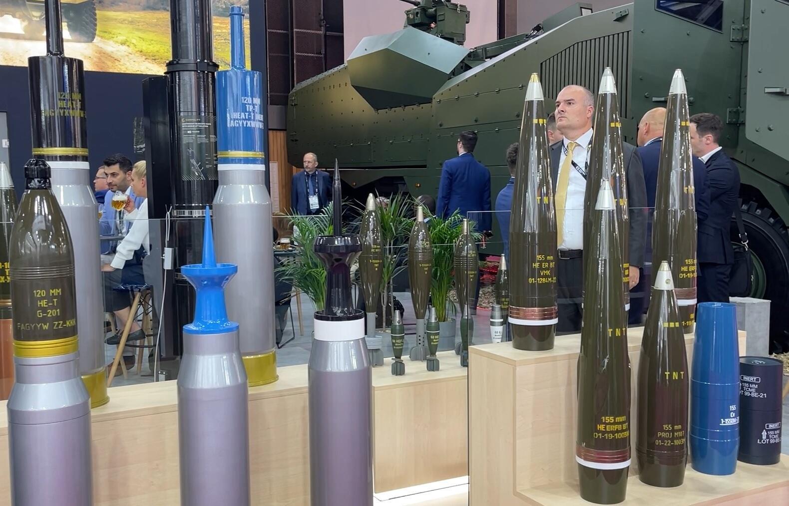 Visitors at the Eurosatory 2024 arms fair in Paris, enjoying a beer amidst shells. 18 June 2024.