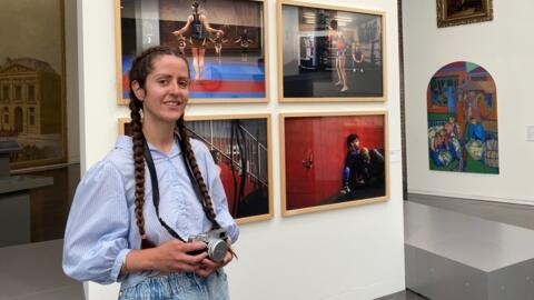 French photographer Anouk Desury posing in front her photo series "Les Poings ouverts" at La Piscine museum in Roubaix, northern France, on 10 July 2024.