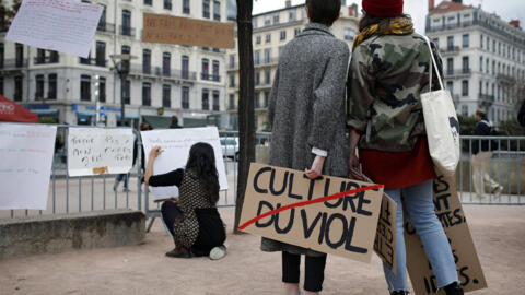 A woman holds a banner that reads: 'Rape Culture' during a demonstration in Lyon, central France.