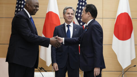 U.S. Secretary of State Antony Blinken, center, looks at Japanese Prime Minister Fumio Kishida, right, shake hands with Defense Secretary Lloyd Austin as they meet at the prime minister's office in To