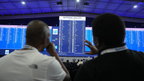 Observers look on as election results are displayed at a results operation centre in Johannesburg, South Africa, on 31 May 2024. 