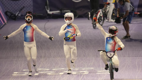 From left, gold medallist Joris Daudet of France, bronze medallist Romain Mahieu of France and silver medallist Sylvain Andre of France celebrate after a BMX racing event, at the 2024 Summer Olympics,