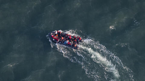 This aerial picture taken on September 16, 2023, from an aircraft belonging to the French Police Aux Frontieres, shows migrants onboard of a dinghy used for smuggling as they attempt to cross the English Channel to Britain from a beach at Le Touquet, northern France.