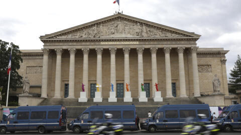 Police vans park outside the National Assembly during the second round of the legislative elections, Sunday, July 7, 2024 in Paris.