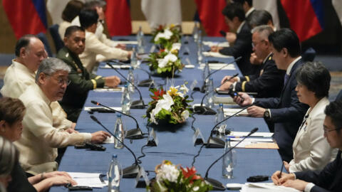 Philippines' Foreign Secretary Enrique Manalo, third from left, and Philippines' Defense Secretary Gilberto Teodoro Jr., talks with Japan Foreign Minister Yoko Kamikawa, second from right, and Japan D