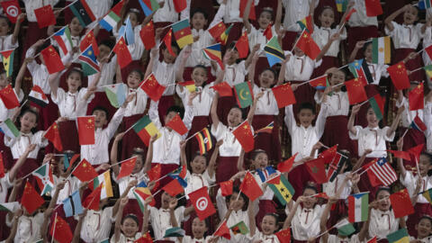 Children wave African and Chinese flags during a reception at the Forum on China-Africa Cooperation (Focac) in Beijing on 4 September, 2024.