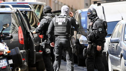 Members of the French RAID police unit leave after searching the home of one of two men arrested in Marseille on 18 April, 2017 after they were suspected of plotting an "imminent" attack in France, days from presidential polls. 