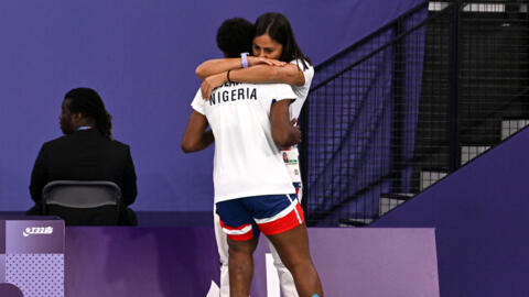 Mariam Eniola Bolaji (left) celebrates with coach Dina Abouzeid after becoming the first African player to win a medal in badminton at the Paralympic or Olympic Games.