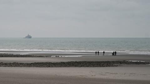 This photograph taken on 14 January, 2024, on the beach of Wimereux, northern France, shows French military ship patrolling in the English Channel.