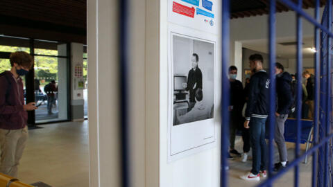 A portrait of Samuel Paty on a wall of a high school in southwestern France as students pay tribute on the first anniversary of his murder, in October 2021. 