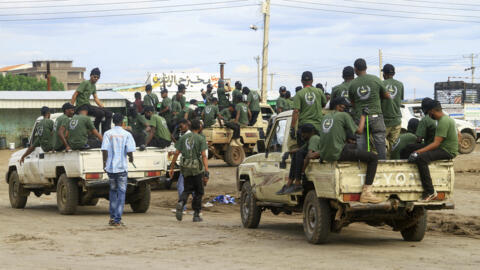 Members of a "joint security cell" made up of various military and security services affiliated with Sudan's army take part in a parade in Gedaref city in the east of the country, on 28 July 2024. 