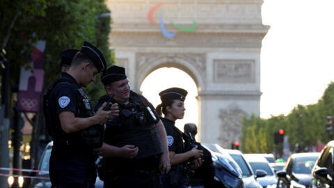 Members of police stand guard after a police officer was injured in an attack next to the Champs-Elysees in Paris, France, on 18 July 2024.