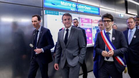 France's President Emmanuel Macron (C) walks with Ligne 14 director Emmanuel Sologny (L) and Saint-Denis' mayor Mathieu Hanotin (R) on a platform of "Mairie de Saint-Ouen" metro station before the inauguration of the new Saint-Denis Pleyel metro station and the extension of the Paris metro's line 14, in Saint-Ouen, North of Paris, on 24 June, 2024.