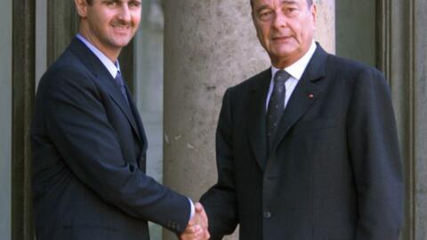 Syrian President Bashar Al-Assad (L) receives the Légion d'honneur from Jacques Chirac in 2001