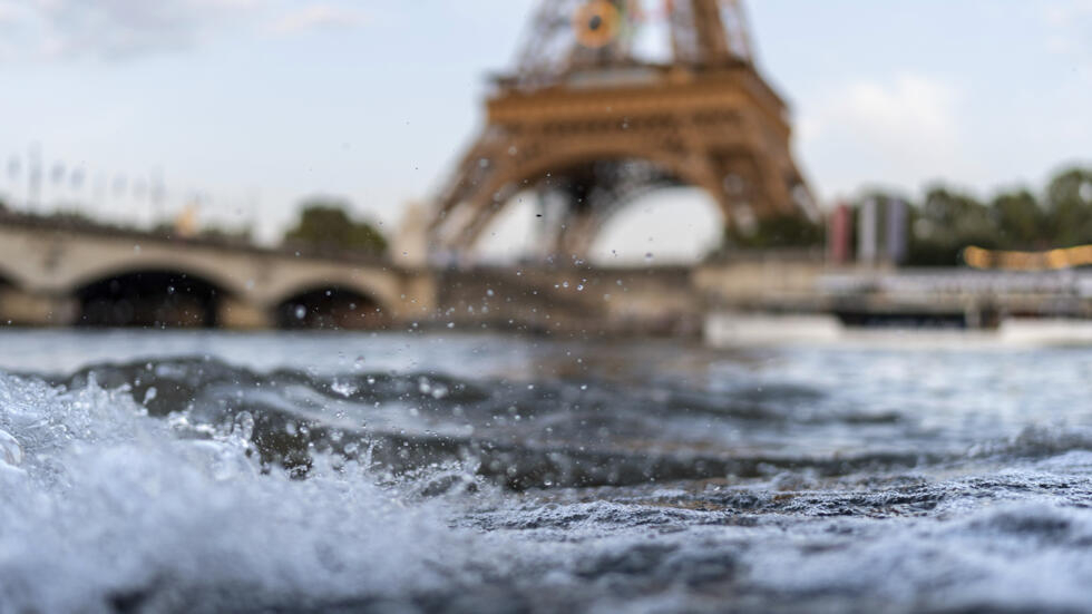 Waves crash along the banks of the Seine River in front of the Eiffel Tower during the 2024 Summer Olympics, Monday, July 29, 2024, in Paris.