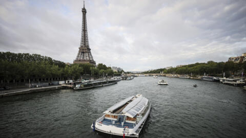 Barges cruise on the Seine river near the Eiffel Tower during a rehearsal for the Paris 2024 Olympic Games opening ceremony, Monday, 17 June, 2024 in Paris.