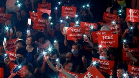 Demonstrators wave their smartphones during a rally ahead of the G20 summit, urging the international community to back their demands for the government to withdraw a the extradition bill in Hong Kong, China June 26, 2019.