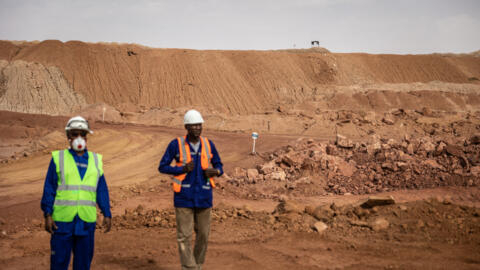 Mine workers stand by the residual dump at a uranium mine near Arlit, Niger on 8 March, 2023. 