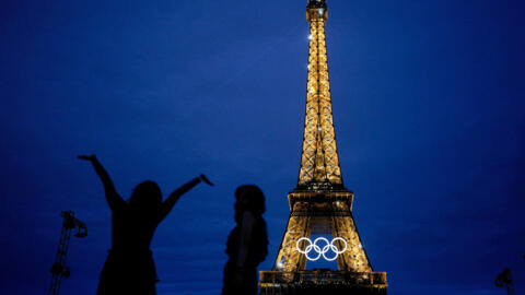 The United States' Amarilees Bolorin, left, takes a selfie with a friend in front of the Eiffel Tower ahead of the 2024 Summer Olympics, Thursday, July 25, 2024, in Paris, France. (AP Photo/Natacha Pisarenko)