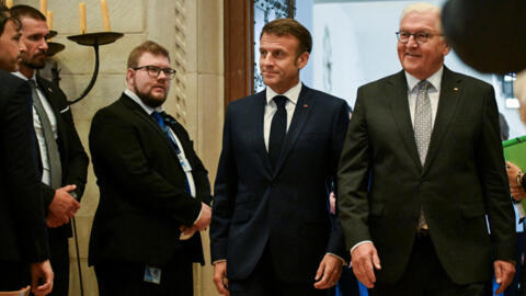 French President Emmanuel Macron walks with German President Frank-Walter Steinmeier on the day Macron is presented with the International Award of the Peace of Westphalia.