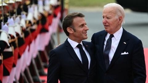 France's President Emmanuel Macron and US President Joe Biden at the International commemorative ceremony at Omaha Beach marking the 80th anniversary of the World War II "D-Day" Allied landings in Normandy, in Saint-Laurent-sur-Mer, in northwestern France, on 6 June 2024. 