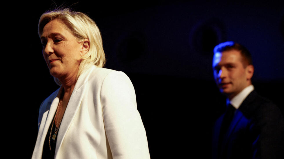 Marine Le Pen, the National Rally's figurehead and presidential candidate, with Jordan Bardella, its leader and candidate for prime minister, at a party rally in Paris on 9 June 2024.