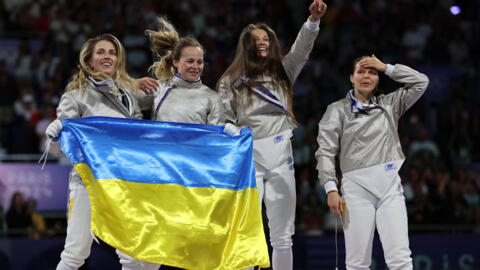 Ukraine's women's fencing team: Olga Kharlan, Alina Komashchuk, Olena Kravatska and Yuliia Bakastova celebrate after winning the Gold medal in women's sabre event, at the Paris Olympics, 3 August 2024.