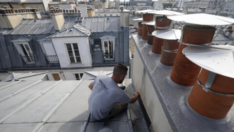 A roofer and zinc worker on the roof of a building in Paris, on 31 July 2024.