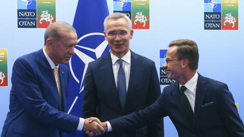 Turkey's President Recep Tayyip Erdogan, left, shakes hands with Sweden's Prime Minister Ulf Kristersson, right, as NATO Secretary General Jens Stoltenberg looks on prior to a meeting ahead of a NATO