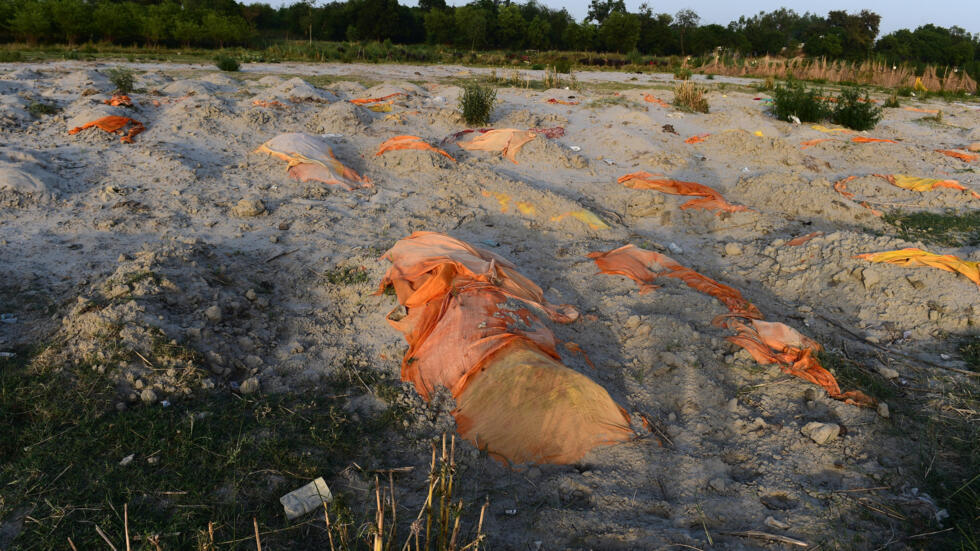 Graves of Covid-19 victims washed up on the banks of the Ganges river in Unnao, India, 13 May 2021.