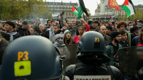 Protestors face French police as they gather in Paris for an unauthorized demonstration in support of Palestinians in Paris, on 12 October, 2023. 