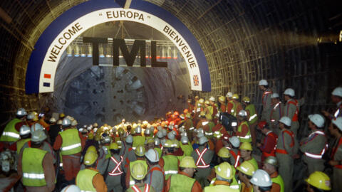 Construction workers celebrate the joining of the French and British sides of the north tunnel under the English Channel, on 22 May 1991.