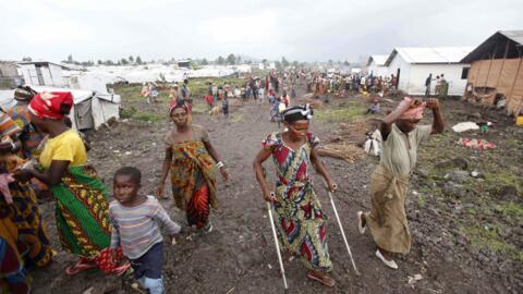 Internally Displaced People (IDP) walking through Mugunga camp, near Goma, in November 2012.