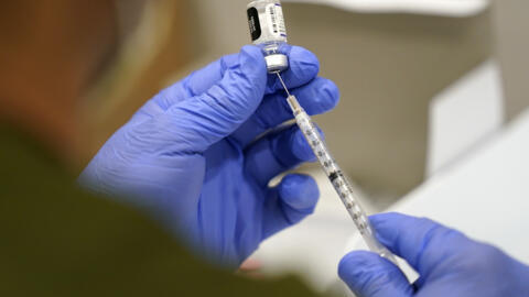 File Photo: A healthcare worker fills a syringe with the Pfizer COVID-19 vaccine on 5 October 2021. France has begun rolling-out its 2023 anti-Covid vaccination campaign early due to a resurgence of the virus over the summer.