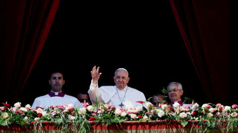 Pope Francis waves from a baclony on the day of his "Urbi et Orbi" ("To the City and the World") message at St. Peter's Square, on Easter Sunday, at the Vatican, April 9, 2023. 