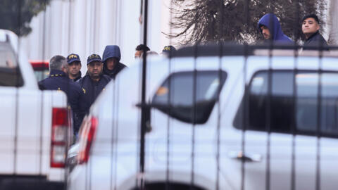 French national rugby players Hugo Auradou and Oscar Jegou are escorted by Argentinian Federal Police, as they leave Interpol headquarters in Buenos Aires.