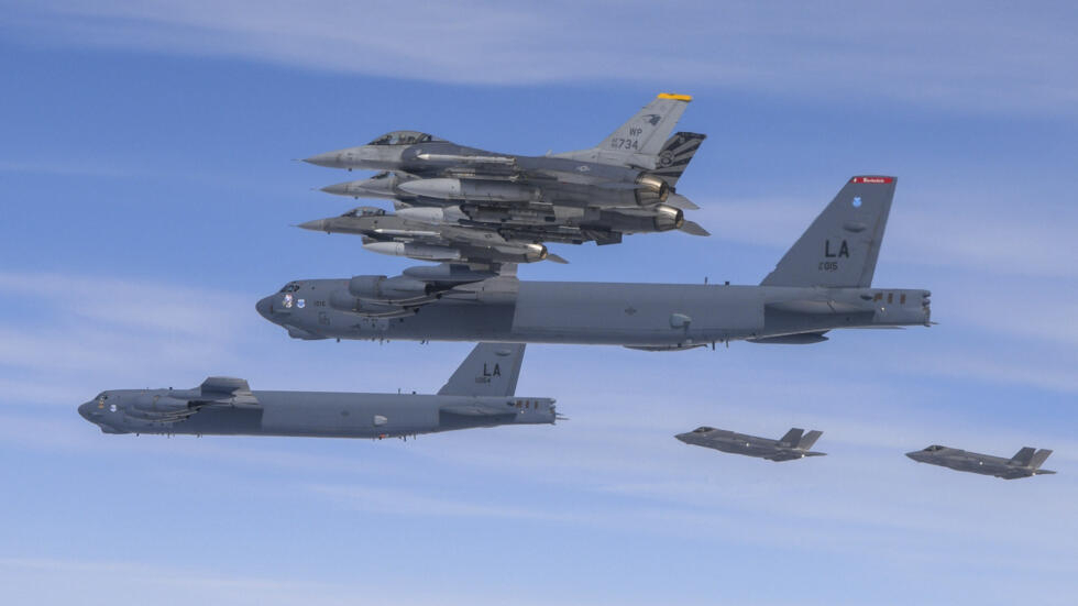 In this photo provided by South Korean Defense Ministry, U.S. B-52H bombers, center, and F-16 fighter jets and South Korean Air Force F-35A fighter jets, right bottom, fly over the Korean Peninsula d
